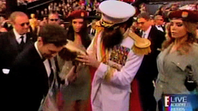 Sacha Baron Cohen spills 'ashes' on Seacrest at Oscars